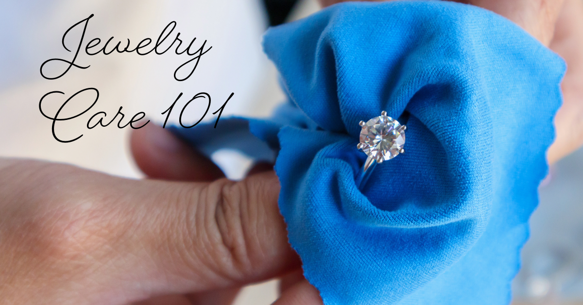 A jeweler cleaning a diamond ring with a blue cloth. 